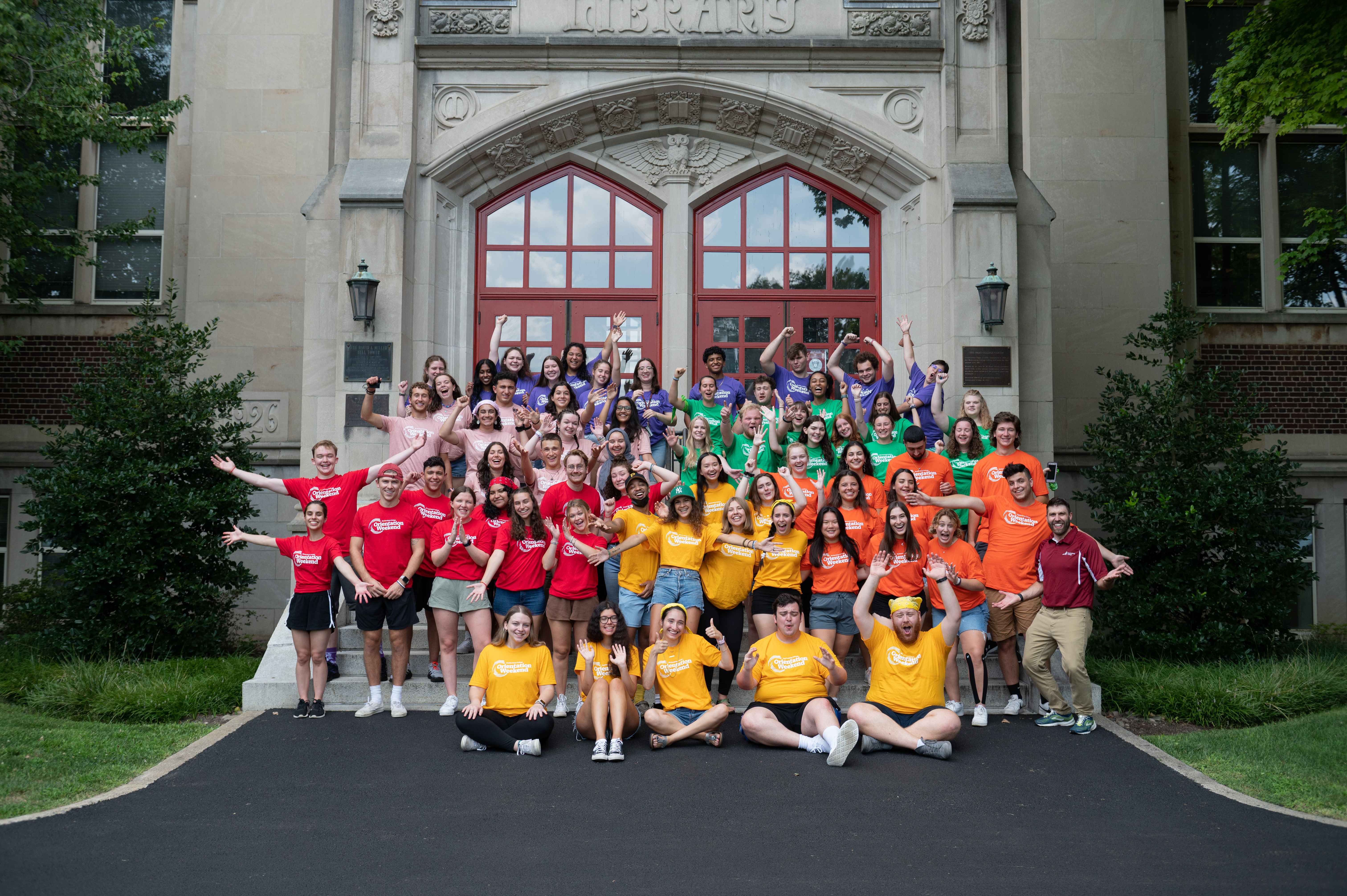 Students posing on front steps of building