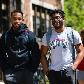 Students posing while walking through campus